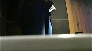 Surveillance video of young girl urinating in the toilet