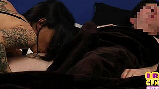 Tattooed domina in bed sucks and jerks guy's cock without clothes on