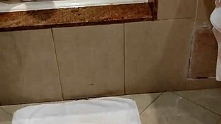 A young man sneaks behind his step-sister and masturbates looking at her big tits