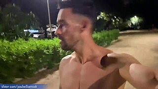 this tall muscular tattooed guy walks naked barefoot on the street, showing his bodybuilder ass