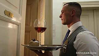 Pornstar gives blowjob while bent over in lingerie.