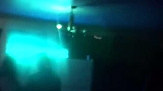 an amateur brunette coed teases and sucks a hard cock at a university party, watched by voyeurs in a group setting.