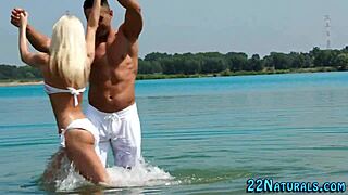 blonde babe performs blowjob on beach