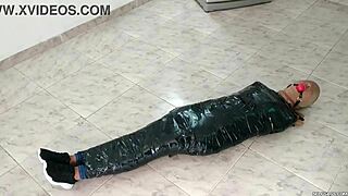 Duct tape mummified girl gets hooded in pantyhose. Sadistic women ball gag her tight! 😈