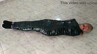 Duct tape mummified girl gets hooded in pantyhose. Sadistic women ball gag her tight! 😈