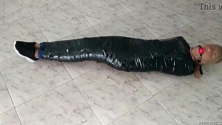 Duct tape mummified girl gets hooded in pantyhose. Sadistic women ball gag her tight! 😈