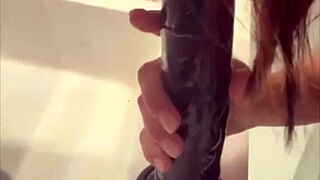 Look at this mature woman using a big black dildo!