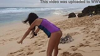 i'm doing yoga on the wild beach with my pink butt plug, no panties on, naked and close-up