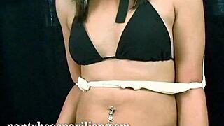 Young black woman muzzled and ridiculed in bikini and tights