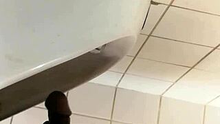 check out this black gay guy stroking at the urinal! 😏