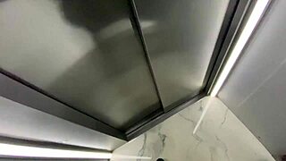 Blonde flashes fake tits in public elevator before cumming