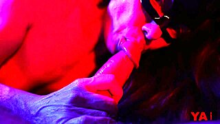 Masked adult sucks huge cock in neon light and swallows cum!