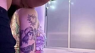 Pretty geek explores bedroom toys with muscular tattooed partner