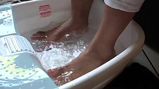 asian beauty teases with wet feet in a steamy foot bath session.