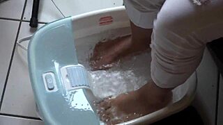 asian beauty teases with wet feet in a steamy foot bath session.