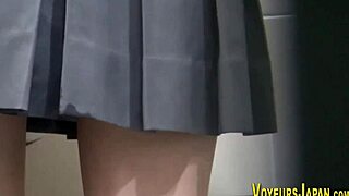 A Japanese teen in uniform explores her body with gentle touches