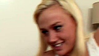 A blonde woman with tattoos bends over for a deep doggystyle encounter in a wet setting.