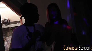 I watch as the redhead sucks and fucks the big black cock through the gloryhole