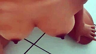 Full-breasted girl receives facial while sitting tight.