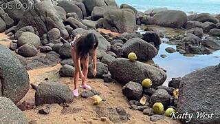 Naked girl pours coconut juice on body