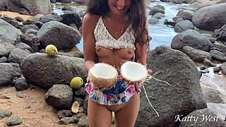 Naked girl pours coconut juice on body