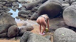 Naked girl pours coconut juice on body