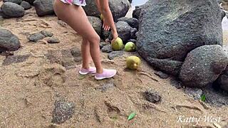 Naked girl pours coconut juice on body