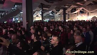 Wow, these wild lesbian babes are kissing and stripping on a public stage!