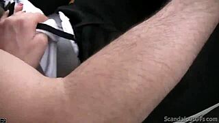 A young woman provides a handjob to a man while the man is in a car and recording