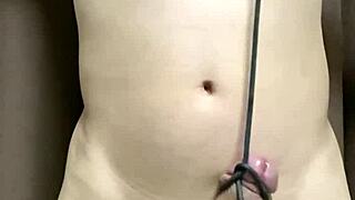 Hey, check out this anime guy tying his dick and balls with string!