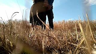 Sexy naked woman posing with big ass and tits in combination with a bureaucratic suit in the nature having oral sex