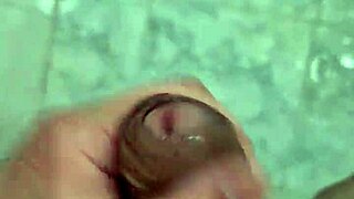 A rather thin young boy having a shower alone