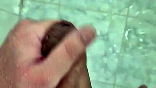 A rather thin young boy having a shower alone