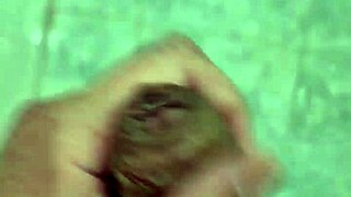 A rather thin young boy having a shower alone