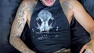 tattooed guy uses dildo in gay scene