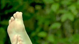 Young redhead teases sensually in outdoor close-ups.