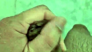 A rather thin young boy having a shower alone