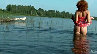 pamela strips naked in a lake, her ginger juice dripping outdoors under the sun.