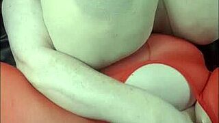 lady with huge tits lies back for fun with a big black cock toy.