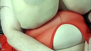 lady with huge tits lies back for fun with a big black cock toy.