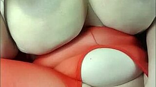 lady with huge tits lies back for fun with a big black cock toy.