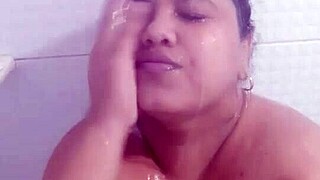 Feeling sexy while bathing and rubbing soap on big tits.