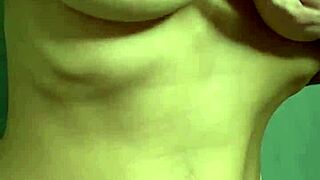 A hot student caresses her big tits solo