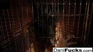 Sexy Dani Daniels masturbating in a cage.