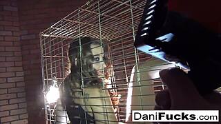 Sexy Dani Daniels masturbating in a cage.