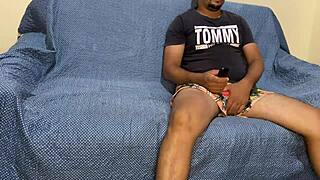 watching tv in the room, the brunette in dress sits close to her husband on the couch