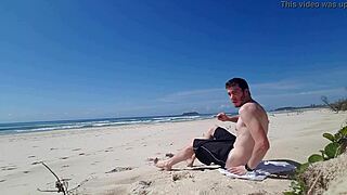 on a sunny beach day, a guy jerks off in public. the outdoor thrill adds to his daring solo act.