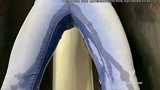Candystripe girl in old rigid jeans takes off pants during a shower scene in this amateur movie