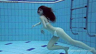 roxalana cheh, the sexy redhead, stuns while swimming underwater in a public spot.