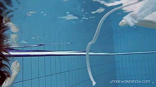 roxalana cheh, the sexy redhead, stuns while swimming underwater in a public spot.